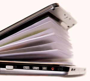 Image of laptop filled with papers