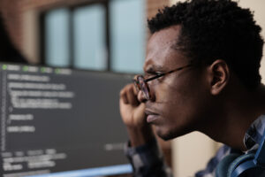 Man studying computer screen